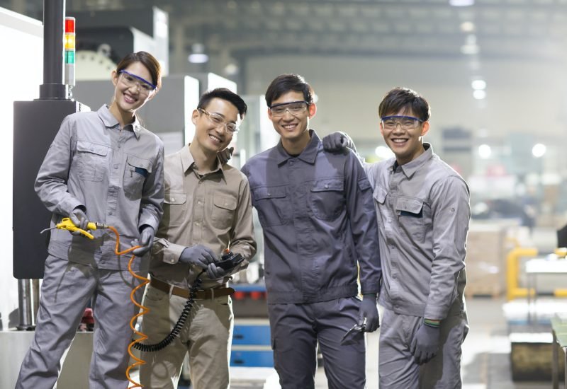 Confident engineering team in the factory